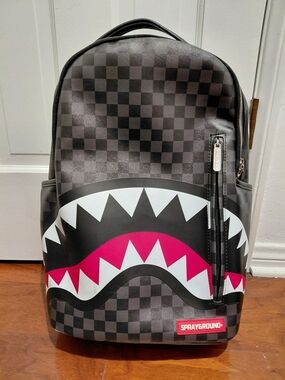 Sprayground Black Checkerboard Backpack with Pink and White Shark Graphic